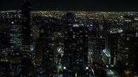 5K stock footage aerial video of Jade at Brickell Bay overlooking the water at night in Downtown Miami, Florida Aerial Stock Footage | AX0023_053