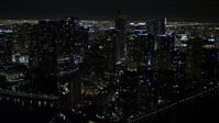 5K stock footage aerial video flyby Brickell Key high-rises at night in Downtown Miami, Florida Aerial Stock Footage | AX0023_055E