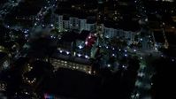 5K stock footage aerial video of approach South Beach office building at night, Florida Aerial Stock Footage | AX0023_126