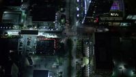5K stock footage aerial video fly over tower and tilt to bird's eye of Brickell Avenue at night in Downtown Miami, Florida Aerial Stock Footage | AX0023_161E