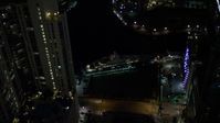 5K stock footage aerial video flyby yacht on the river and Downtown Miami skyscrapers at night, Florida Aerial Stock Footage | AX0023_170E