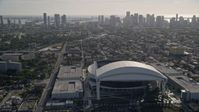 5K stock footage aerial video tilt from Marlins Park revealing Downtown Miami skyline, Florida Aerial Stock Footage | AX0024_033