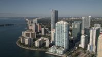 5K stock footage aerial video fly over Mandarin Oriental on Brickell Key toward skyscrapers and apartment buildings in Downtown Miami, Florida Aerial Stock Footage | AX0024_044E