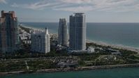 5K stock footage aerial video of flying by Portofino Tower and skyscrapers, South Beach, Miami Beach, Florida Aerial Stock Footage | AX0024_075