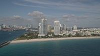 5K stock footage aerial video of flying over Atlantic Ocean, reveal South Beach skyscrapers, Miami Beach, Florida Aerial Stock Footage | AX0024_112