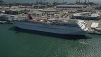 5K stock footage aerial video of a Carnival Cruise Ship at Port of Miami, Florida Aerial Stock Footage | AX0031_042