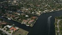 5K stock footage aerial video of following canal, tilt down on mansions, Fort Lauderdale, Florida Aerial Stock Footage | AX0031_140