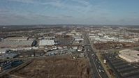 5K stock footage aerial video follow Broadhollow Road to approach stores and shopping centers in Farmingdale, Long Island, New York, winter Aerial Stock Footage | AX0065_0002