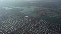 5K stock footage aerial video tilt from a bird's eye view of urban neighborhoods to reveal bridges spanning the East River in Queens, New York City, winter Aerial Stock Footage | AX0065_0040E