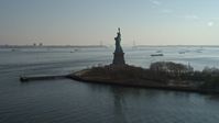 5K stock footage aerial video flyby the back of the Statue of Liberty, New York, winter Aerial Stock Footage | AX0065_0076E