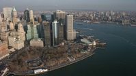 5K stock footage aerial video of Lower Manhattan skyscrapers and Battery Park in winter, New York City, winter Aerial Stock Footage | AX0065_0137E
