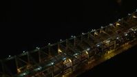 5K stock footage aerial video track slow traffic crossing the Queensboro Bridge, New York City, winter, night Aerial Stock Footage | AX0065_0314E