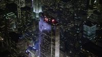 5K stock footage aerial video of flying away from Rockefeller Center in Midtown Manhattan, New York City, winter, night Aerial Stock Footage | AX0065_0339