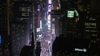 5K stock footage aerial video of skyscrapers, bright screens and tourist crowds at Times Square in Midtown Manhattan, New York City, winter, night Aerial Stock Footage | AX0065_0351E