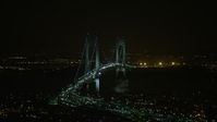 5K stock footage aerial video of passing by the Verrazano-Narrows Bridge in New York City, winter, night Aerial Stock Footage | AX0065_0399E