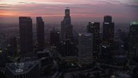 7.6K stock footage aerial video of towering skyscrapers around the Westin Bonaventure Hotel in Downtown Los Angeles at sunrise, California Aerial Stock Footage | AX0156_055