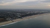 7.6K stock footage aerial video of light traffic on Pacific Coast Highway on the edge of Pacific Palisades / Santa Monica at sunrise, California Aerial Stock Footage | AX0156_167