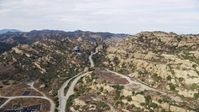 7.6K stock footage aerial video flying over road leading to Aerojet Rocektdyne testing facility,  Brandeis, CA Aerial Stock Footage | AX0157_040