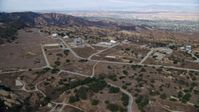 7.6K stock footage aerial video approaching roads and buildings of the Rocektdyne aerospace testing facility, Brandeis, California Aerial Stock Footage | AX0157_047