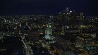 7.6K stock footage aerial video orbiting LA City Hall to reveal skyscrapers at night in Downtown Los Angeles, California Aerial Stock Footage | AX0158_108