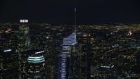 7.6K stock footage aerial video circling the top of Wilshire Grand Center at night in Downtown Los Angeles, California Aerial Stock Footage | AX0158_113