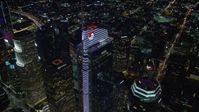 7.6K stock footage aerial video orbiting and tilt to a bird's eye of Wilshire Grand Center in Downtown Los Angeles, California at night Aerial Stock Footage | AX0158_122