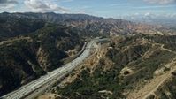 7.6K stock footage aerial video following light traffic on I-5 through the mountains, Santa Clarita, California Aerial Stock Footage | AX0159_010