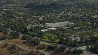 7.6K stock footage aerial video orbiting away from College Institute of the Arts and its parking lot, Santa Clarita, California Aerial Stock Footage | AX0159_019