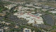 7.6K stock footage aerial video of a reverse orbit of a shopping mall and parking lot, Santa Clarita, California Aerial Stock Footage | AX0159_029