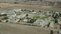 7.6K stock footage aerial video passing by the California Institution for Men prison in Chino, California Aerial Stock Footage | AX0159_144