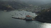 7.6K stock footage aerial video approaching boats anchored in Avalon Bay harbor by the island town on Santa Catalina Island, California Aerial Stock Footage | AX0159_262