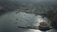 7.6K stock footage aerial video flying by boats in Avalon Bay harbor and the island town of Avalon on Santa Catalina Island, California Aerial Stock Footage | AX0159_263