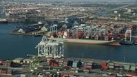 7.6K stock footage aerial video of cranes loading containers onto a ship at the Port of Long Beach, California Aerial Stock Footage | AX0161_009