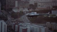 7.6K stock footage aerial video tracking an LAPD helicopter flying over Downtown Los Angeles, California at twilight Aerial Stock Footage | AX0162_096