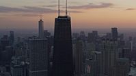 4K stock footage aerial video of flying away from John Hancock Center, tilt to reveal Lake Shore Drive at sunset, Downtown Chicago, Illinois Aerial Stock Footage | AX0170_0021