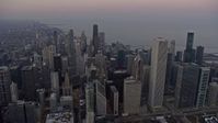 4K stock footage aerial video passing downtown's tall skyscrapers at sunset, Downtown Chicago, Illinois Aerial Stock Footage | AX0170_0036