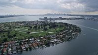 6.7K stock footage aerial video a view of the Miami skyline seen from Miami Beach golf course and waterfront homes, Florida Aerial Stock Footage | AX0172_075