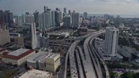 6.7K stock footage aerial video tilt from bird's eye of traffic on I-95, approach tall skyscrapers in Downtown Miami, Florida Aerial Stock Footage | AX0172_113