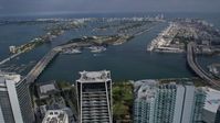 6.7K stock footage aerial video tilt from skyscrapers in Downtown Miami, Florida, reveal islands in the bay Aerial Stock Footage | AX0172_116