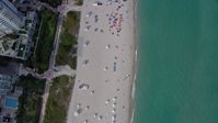 6.7K stock footage aerial video a view of a bird's eye view of sunbathers in South Beach, Miami, Florida Aerial Stock Footage | AX0172_135