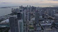 6.7K stock footage aerial video tilt from Downtown Miami streets to reveal and approach skyscrapers at sunset, Miami, Florida Aerial Stock Footage | AX0172_184