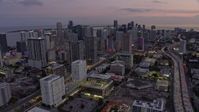 6.7K stock footage aerial video tilt from I-95 to reveal and approach Downtown Miami skyscrapers at twilight, Florida Aerial Stock Footage | AX0172_204