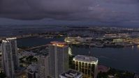6.7K stock footage aerial video of flying over skyscrapers in Downtown Miami toward port and Jungle Island at twilight, Florida Aerial Stock Footage | AX0172_213