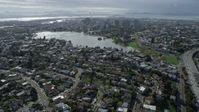 6K stock footage aerial video of approach Lake Merritt and downtown from urban neighborhoods, Oakland, California Aerial Stock Footage | AX0173_0013