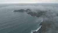 6K stock footage aerial video of flying by wisps of fog over coastal cliffs, Marin Headlands, California Aerial Stock Footage | AX0173_0099