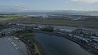 6K stock footage aerial video of flying past runways and hangars at Oakland Airport, California Aerial Stock Footage | AX0173_0137