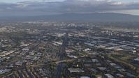6K stock footage aerial video of tilting from the 880 freeway in Milpitas to reveal Downtown San Jose in the distance, California Aerial Stock Footage | AX0174_0020