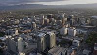 6K stock footage aerial video of flying by office and apartment buildings in Downtown San Jose at sunset, California Aerial Stock Footage | AX0174_0027