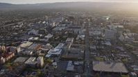 6K stock footage aerial video of tilting from urban homes to reveal Downtown San Jose at sunset, California Aerial Stock Footage | AX0174_0029