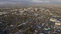 6K stock footage aerial video of tilting from urban homes to reveal Downtown San Jose at sunset, California Aerial Stock Footage | AX0174_0034